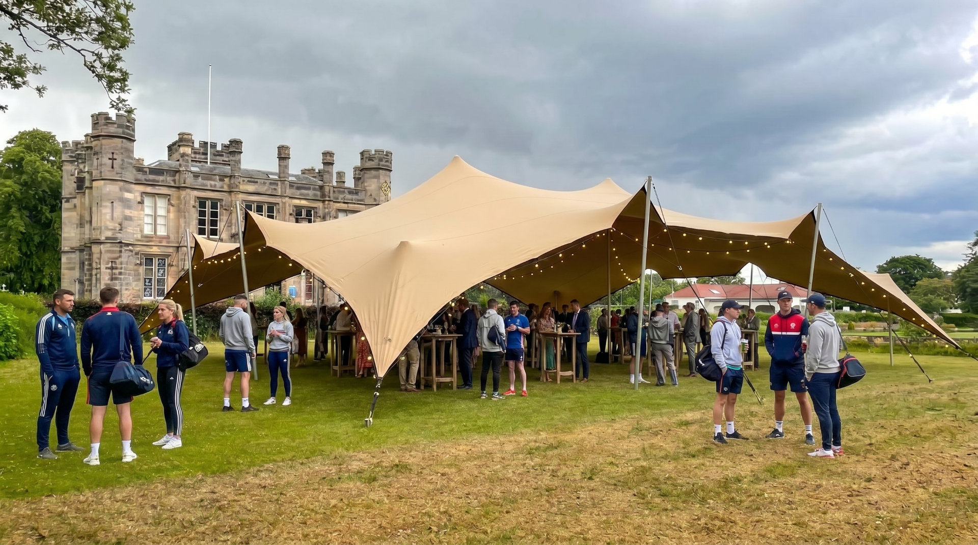 A stretch tent canopy on the Kinburn lawn with people gathered beneath it
